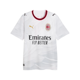 A white Puma AC Milan soccer jersey with a subtle wavy pattern, featuring the gold Puma cat logo, the red and black AC Milan club crest, and the black Emirates Fly Better sponsor text across the chest.