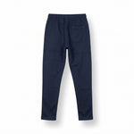 Navy blue tracksuit pants with a white logo on a light gray background
