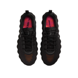 Top view of black Nike Mind 002 women training shoes with orange accents