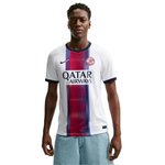 A male model wearing a white Paris Saint-Germain soccer jersey with a vertical navy and red striped pattern, featuring the 'Qatar Airways' sponsor logo and the Nike swoosh.