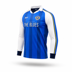 A long-sleeve soccer jersey with vertical blue stripes, white sleeves, and yellow and blue stripes on the shoulders. The jersey features 'THE BLUES' text on the chest, a crest on the left chest, and 'BLK' branding on the right chest.