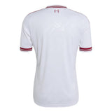 White short-sleeve soccer jersey shown from the back, featuring thin red stripes on the collar and sleeve cuffs, and a small red crest centered below the neckline.