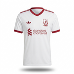 White Adidas Liverpool football jersey with red trim, featuring the Liverpool club crest, Adidas trefoil logo, and Standard Chartered sponsor logo.