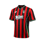 A short-sleeve soccer jersey with vertical red and black stripes, featuring a green and white V-neck collar, a black side panel, a green side stripe, a white 'Milano' script logo on the chest, and a small club crest on the opposite chest.
